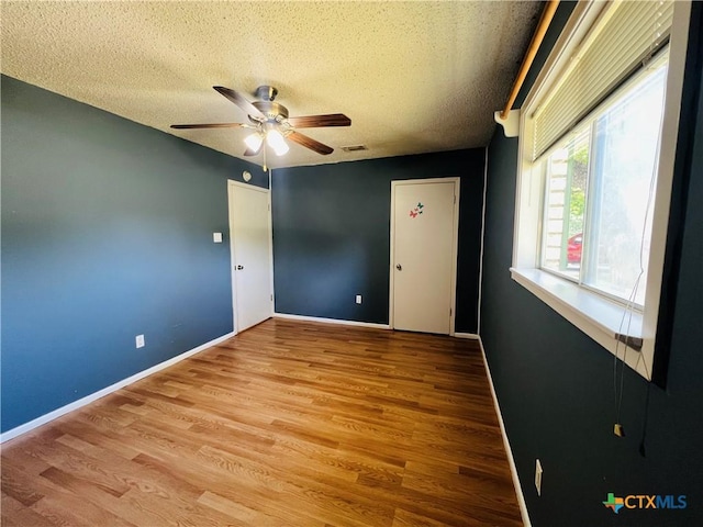 212 Brook St, Seguin, TX 78155 - unfurnished room featuring a ceiling fan, wood finished floors, and a textured ceiling
