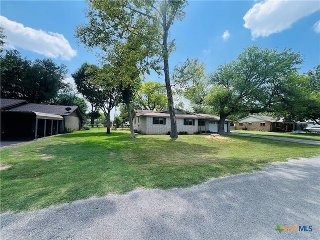 212 Brook St, Seguin, TX 78155 - view of front of home with a carport, driveway, and a front yard