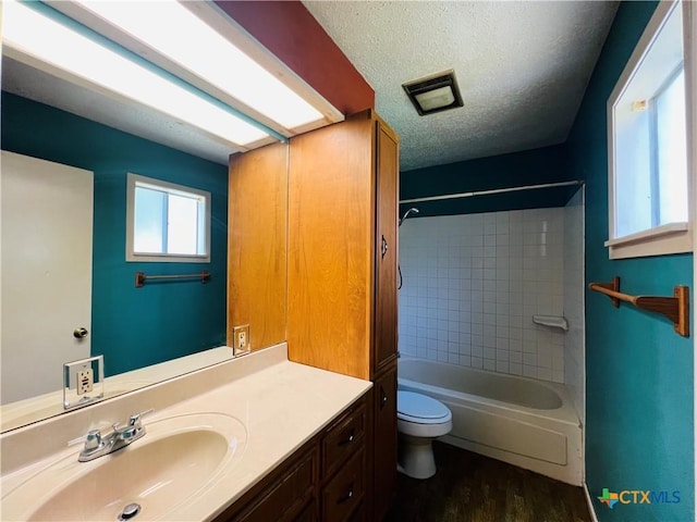 212 Brook St, Seguin, TX 78155 - full bath featuring vanity, wood finished floors, bathing tub / shower combination, and a textured ceiling