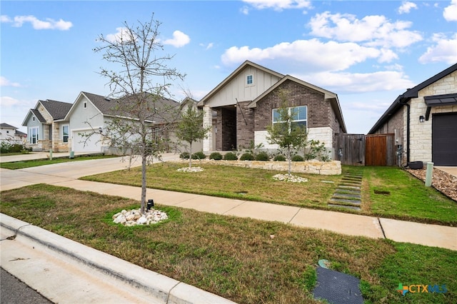 view of front of home with a garage, brick siding, concrete driveway, a front lawn, and board and batten siding