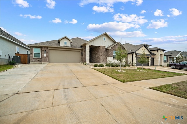 view of front of house with central AC, a front lawn, and a garage