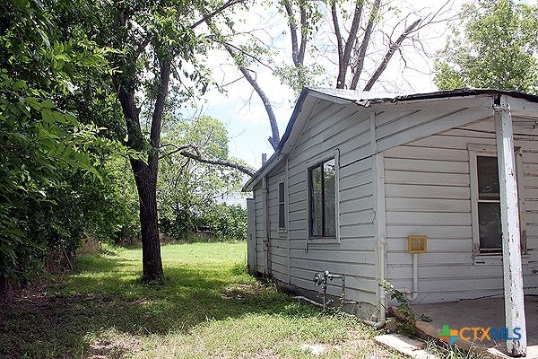 view of side of home featuring a lawn