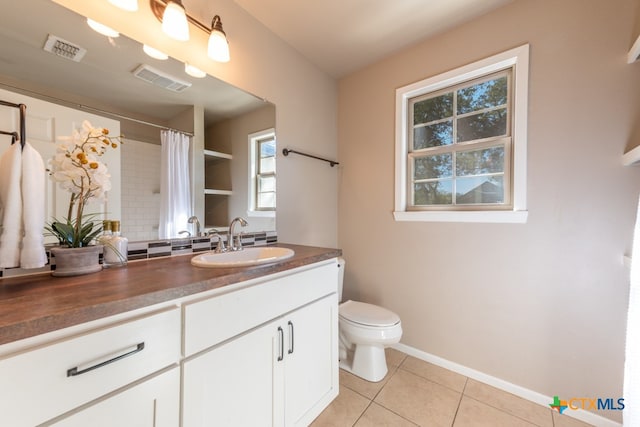 bathroom featuring a shower with curtain, tile patterned flooring, vanity, and toilet