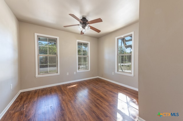 empty room with ceiling fan and dark wood-type flooring