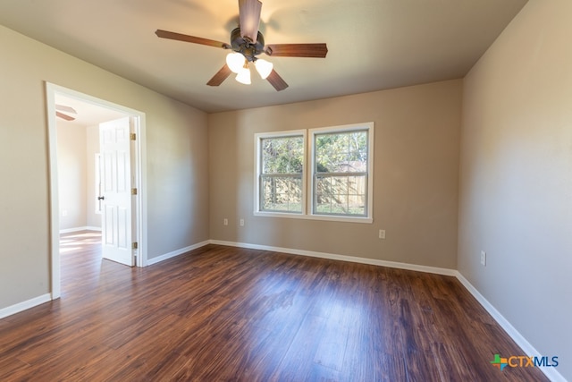 spare room featuring ceiling fan and dark wood-type flooring