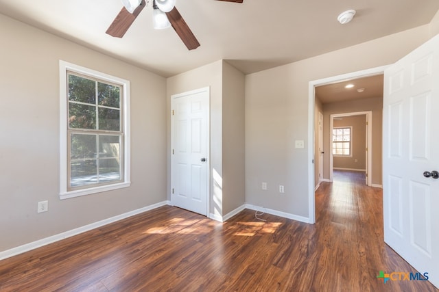 unfurnished bedroom with ceiling fan and dark hardwood / wood-style flooring