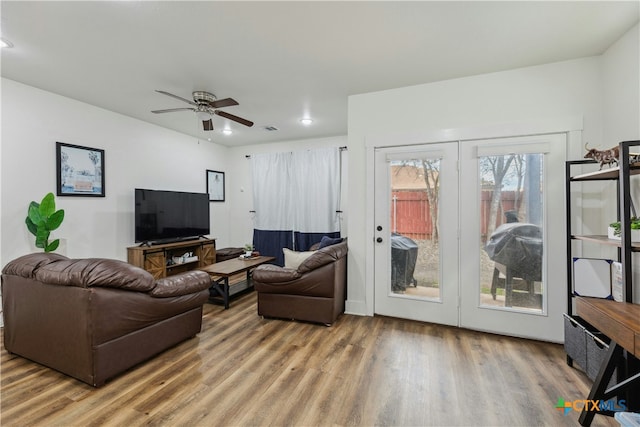 living area with ceiling fan and wood finished floors