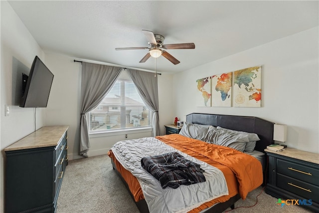 bedroom with ceiling fan and light colored carpet