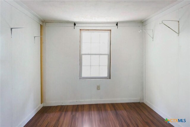 709 Burkett St, Taylor, TX 76574 - spare room with wood finished floors and baseboards