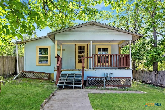 709 Burkett St, Taylor, TX 76574 - bungalow-style home featuring a porch