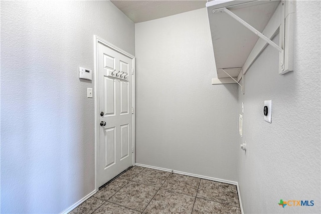 clothes washing area featuring light tile patterned floors