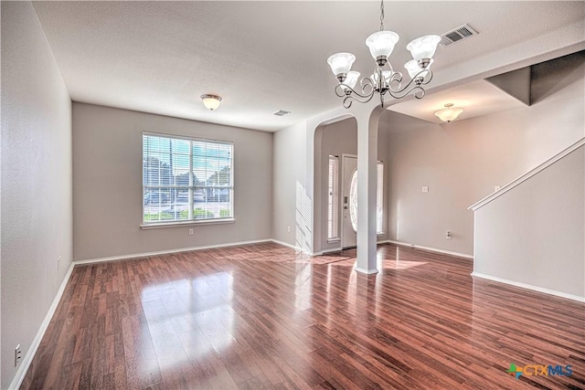 interior space with dark wood-type flooring and a chandelier