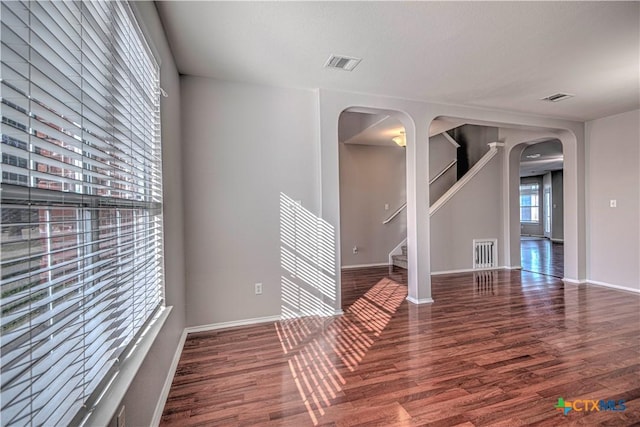 empty room featuring dark hardwood / wood-style flooring