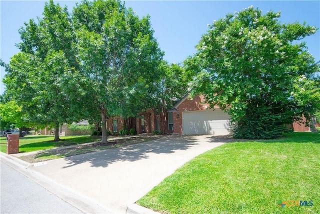 2210 Addax Trl, Harker Heights, TX 76548 - view of property hidden behind natural elements with a front yard, asphalt driveway, brick siding, and a garage