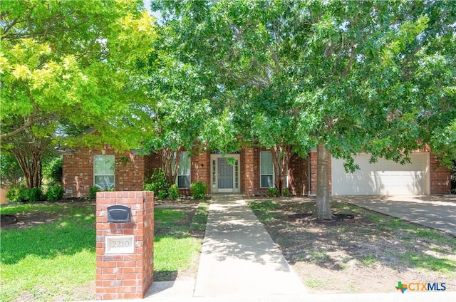 2210 Addax Trl, Harker Heights, TX 76548 - obstructed view of property featuring brick siding, driveway, and a garage