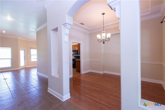 2210 Addax Trl, Harker Heights, TX 76548 - unfurnished dining area with arched walkways, ornamental molding, and a chandelier