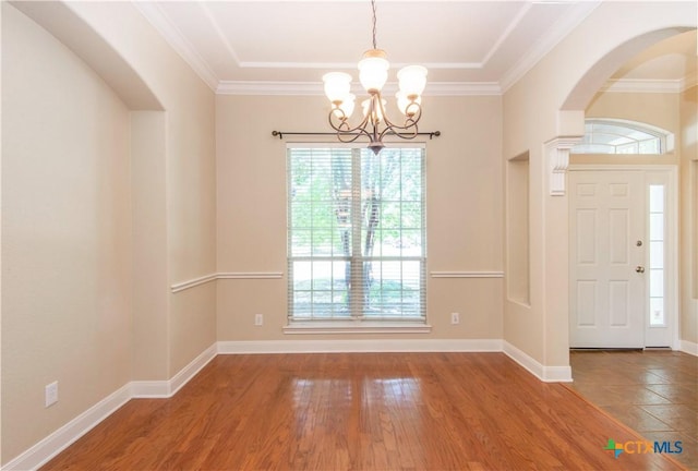 2210 Addax Trl, Harker Heights, TX 76548 - entrance foyer with a chandelier, wood finished floors, ornamental molding, and arched walkways