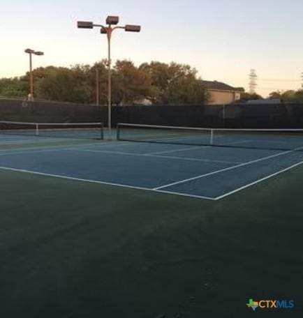 view of sport court featuring fence