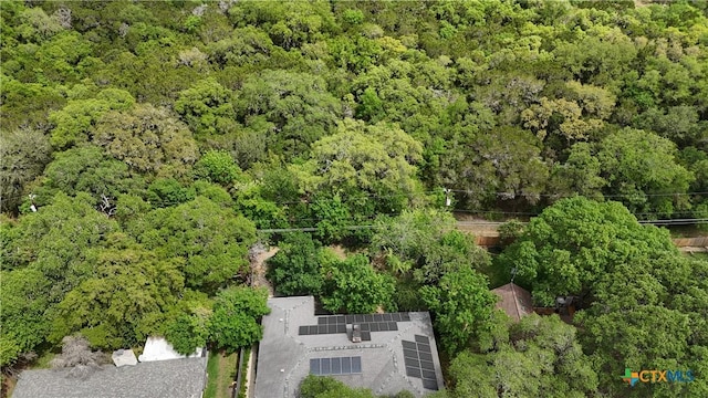 drone / aerial view featuring a wooded view