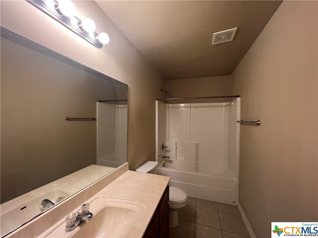 full bathroom featuring tile patterned floors, vanity, a textured ceiling, shower / bath combination, and toilet