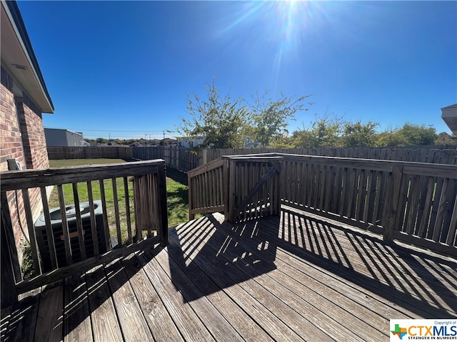 wooden terrace featuring a lawn