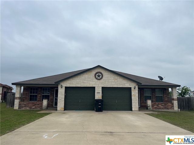 view of front of home with a garage and a front yard