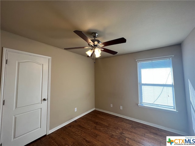 spare room with ceiling fan, dark hardwood / wood-style floors, and a textured ceiling