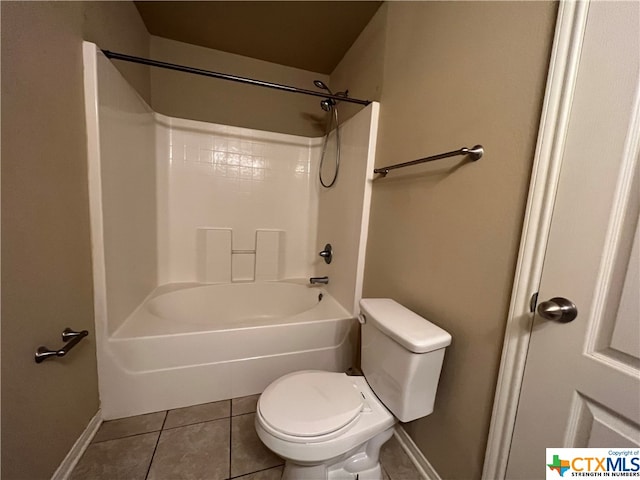 bathroom with tile patterned floors, toilet, and shower / washtub combination