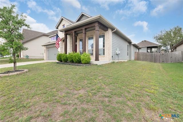 view of front of home featuring concrete driveway, an attached garage, fence, and a front lawn