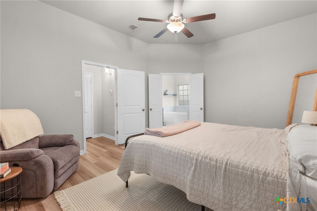 bedroom with light wood-type flooring, a ceiling fan, baseboards, and visible vents