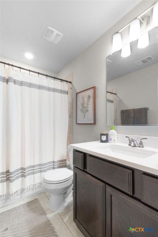 bathroom with visible vents, tile patterned floors, toilet, and vanity