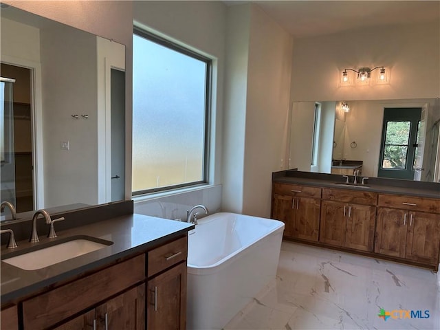 5903 Whippoorwill Rd, Temple, TX 76502 - full bath featuring a freestanding tub, marble finish floors, and two vanities
