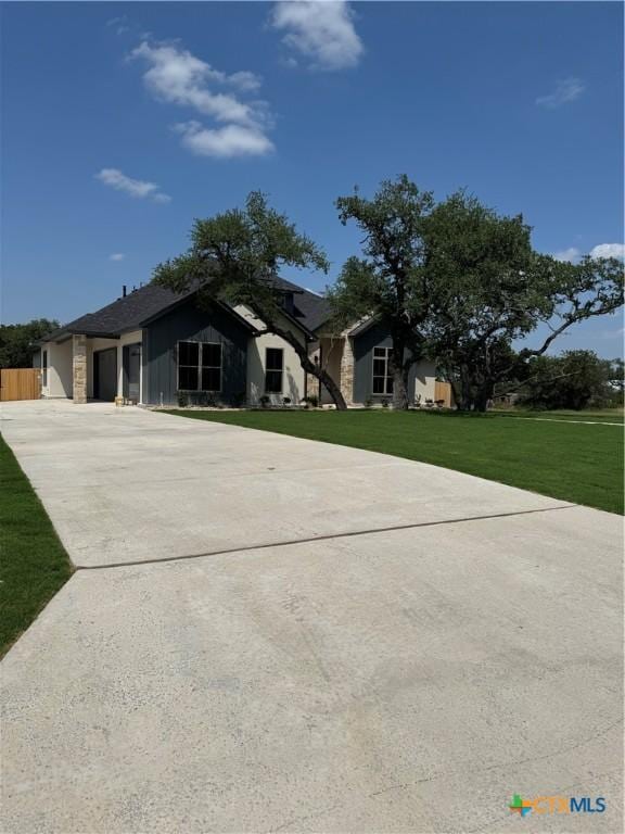 5903 Whippoorwill Rd, Temple, TX 76502 - view of front of house with concrete driveway, a front lawn, and a garage