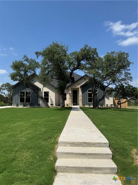 5903 Whippoorwill Rd, Temple, TX 76502 - view of front facade with a front lawn and board and batten siding