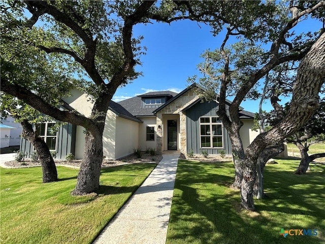 5903 Whippoorwill Rd, Temple, TX 76502 - view of front of property featuring stone siding, a front lawn, and a shingled roof