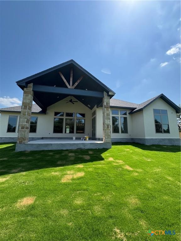 5903 Whippoorwill Rd, Temple, TX 76502 - back of house featuring ceiling fan, stucco siding, a patio, and a lawn