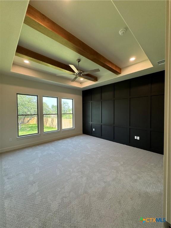 5903 Whippoorwill Rd, Temple, TX 76502 - unfurnished bedroom featuring a tray ceiling, carpet, beamed ceiling, and recessed lighting