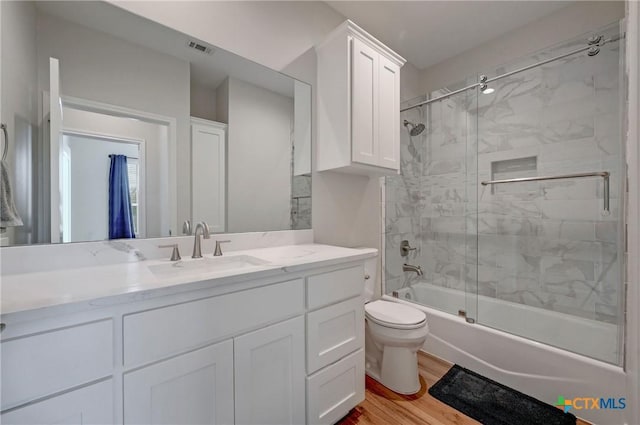 1512 Stonecrest Dr, Granite Shoals, TX 78654 - full bath featuring toilet, vanity, wood finished floors, and enclosed tub / shower combo