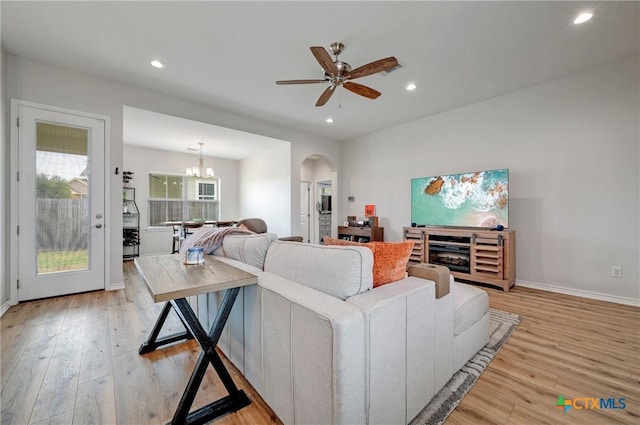 1512 Stonecrest Dr, Granite Shoals, TX 78654 - living room with light wood-type flooring, arched walkways, ceiling fan, recessed lighting, and a chandelier