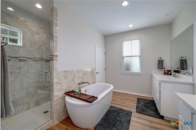 1512 Stonecrest Dr, Granite Shoals, TX 78654 - full bathroom featuring vanity, a shower stall, a freestanding bath, tile walls, and recessed lighting