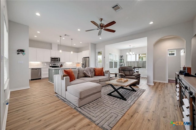 1512 Stonecrest Dr, Granite Shoals, TX 78654 - living area with arched walkways, light wood finished floors, a ceiling fan, baseboards, and recessed lighting