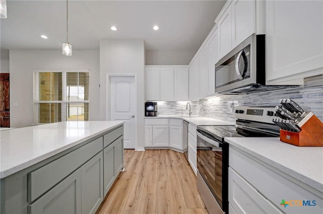 1512 Stonecrest Dr, Granite Shoals, TX 78654 - kitchen with stainless steel appliances, backsplash, light wood-type flooring, white cabinetry, and recessed lighting
