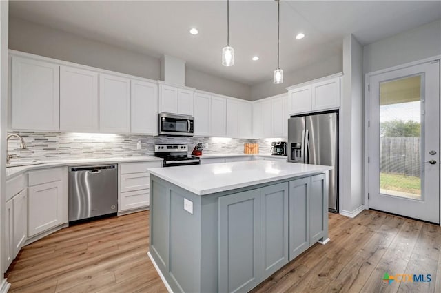 1512 Stonecrest Dr, Granite Shoals, TX 78654 - kitchen with stainless steel appliances, decorative backsplash, light wood finished floors, white cabinets, and recessed lighting