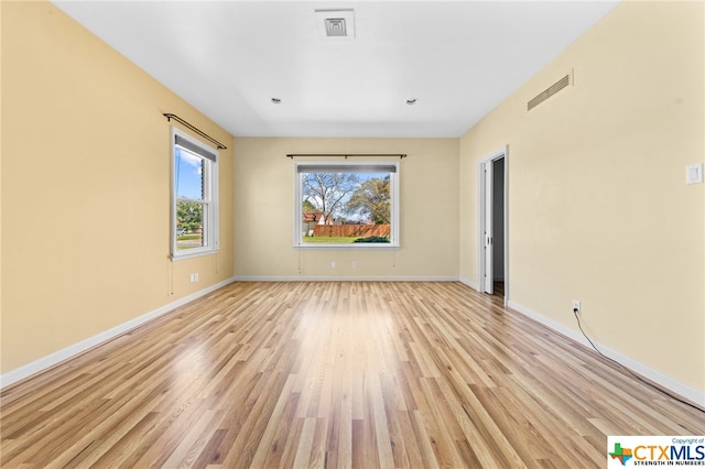 spare room with light hardwood / wood-style floors