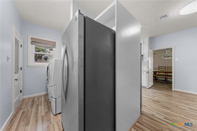 laundry room with light wood-type flooring