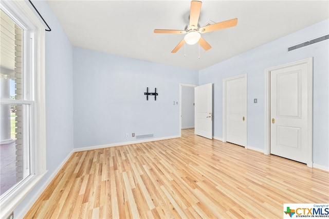 unfurnished bedroom featuring light wood-type flooring and ceiling fan