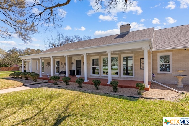 view of front facade with a front yard and a porch