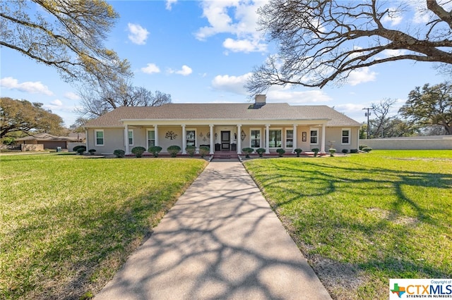 ranch-style home with a front yard and covered porch