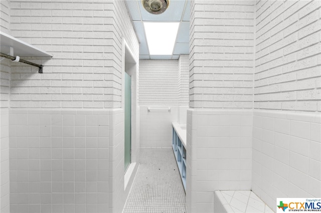 bathroom featuring tile walls and tile patterned flooring