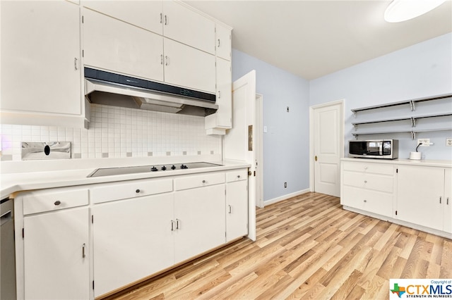 kitchen with light hardwood / wood-style floors, white cabinetry, appliances with stainless steel finishes, and tasteful backsplash